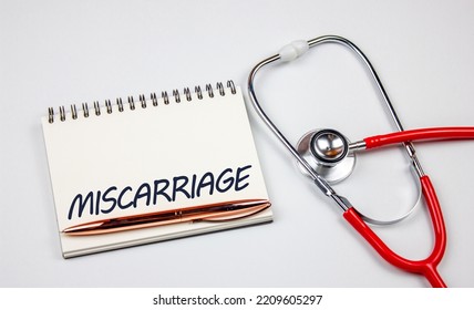 The Miscarriage Word On Notepad.Miscarriage Diagnosis, Spontaneous Abortion Concept.