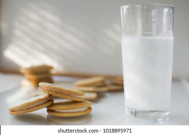 miscellaneous cookies, next to milk on a soft light background, homemade, rustic with light from the window