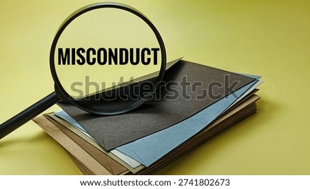 Misconduct concept seen through magnifying glass on multiple envelopes representing investigation wrongdoing compliance violation audit. 