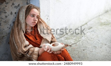 Miser alone grief fail lost cry feel starv mood young lone jew widow lady prayer hand hold empty oil jug bowl lamp sit pray god faith hope. Old retro biblic famine history veil church fence text space