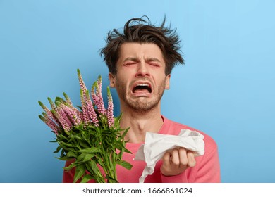 Miserable Man In Depression Suffers From Allergic Malaise And Rhinitis, Seasonal Disease, Tired Of Sneezing, Has Red Nose And Eyes, Allergy To Flowering, Holds Handkerchief, Feels Irritation