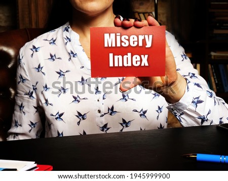  Misery Index inscription on red business card.
