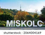 Miskolc text sign in the Park downtown with radio tv tower background