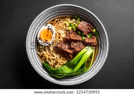 Miso Ramen Asian noodles soup with beef, egg and pak choi cabbage on black background, top view. ストックフォト © 