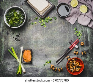 Miso Soup Cooking Ingredients On Rustic Vintage Background With Chopsticks, Top View, Frame. Asian Food Or Japanese Cuisine Concept