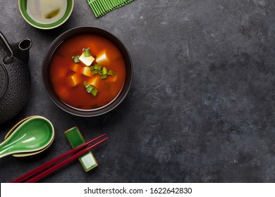 Miso Traditional Japanese Soup With Tofu And Spring Onion. With Green Tea In Pot And Bowls. Top View With Copy Space