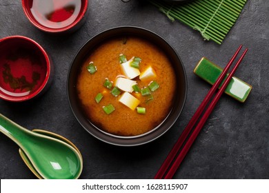 Miso Traditional Japanese Soup With Tofu And Spring Onion. With Green Tea In Pot And Bowls. Top View