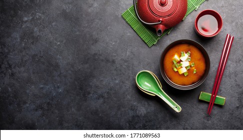 Miso Traditional Japanese Soup With Tofu And Spring Onion. With Green Tea In Pot And Bowl. Top View With Copy Space. Wide Backdrop