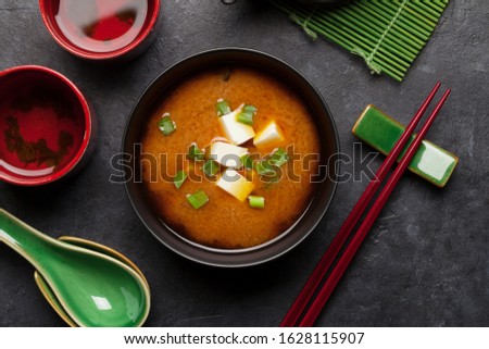 Miso traditional Japanese soup with tofu and spring onion. With green tea in pot and bowls. Top view ストックフォト © 