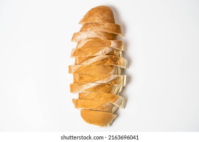 Misplaced Sliced ​​loaf Of Bread On White Background, Overhead View. Food Concept