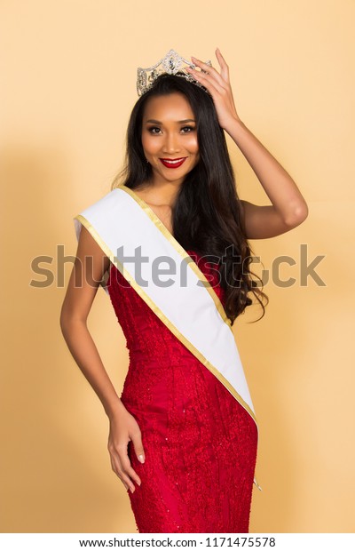 Miss Beauty Pageant Queen Contest in Asian Evening\
Ball Gown sequin dress with Diamond Crown Sash, fashion make up\
face eyes love heart hair style, studio lighting beige background\
isolated copy space