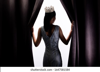 Miss Pageant Beauty Contest Wears Sequin Evening Gown Long Dress With Sparkle Diamond Crown, Asian Woman Opens Purple Curtain After Win Final Round As New Way Life, Opportunity, Change, Isolated