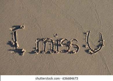 I Miss U Message Written On Sand