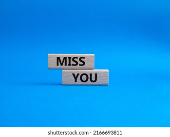 Miss you. Concept word Miss you on wooden cubes. Beautiful blue background. Business and Miss you concept. Copy space. Conceptual image