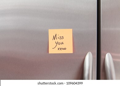 Miss You Post It Note On A Home Kitchen Refrigerator.