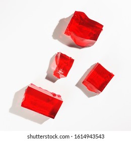 Misshapen pieces of red jelly, isolated on a white background
