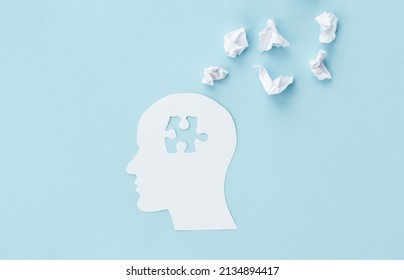 missing jigsaw puzzle of human brain on blue background. Creative idea for solving problem. Mental health care.