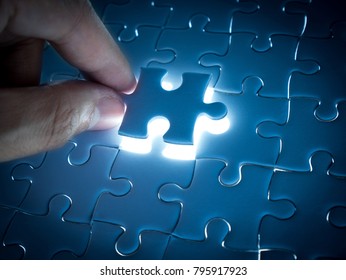 Missing Jigsaw puzzle piece with lighting, business concept for completing the finishing puzzle piece.