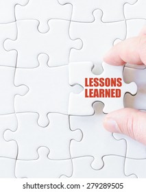 Missing jigsaw puzzle piece with words LESSONS LEARNED. Business concept image for completing the puzzle.