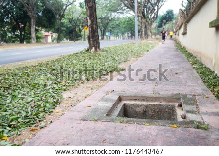 Missing manhole cover in the middle of walkway is dangerous to pedestrians