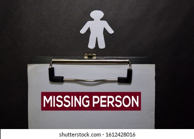 Missing Person Write On A Book Isolated On Black Table.