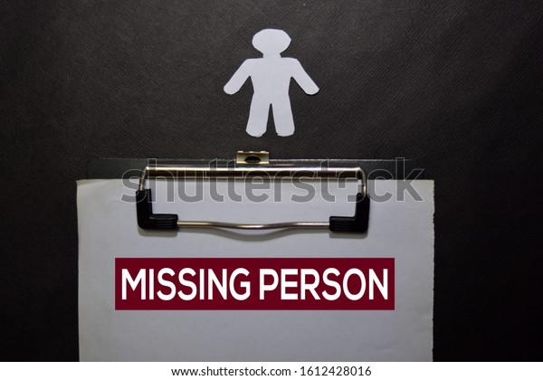 Missing\
Person write on a book isolated on black\
table.