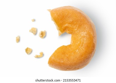 Missing piece of plain donut with crumbs on white background.