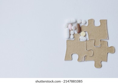 Missing Puzzle Filled With Various Tablets. Copy Space And Creative Concept For Recovery Medication Program And Healthy Lifestyle. 