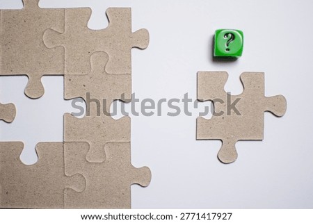 Missing puzzle piece with question cube, concept of incomplete solution, search for answer and uncertainty