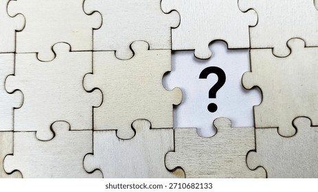 Missing puzzle piece with question mark on wooden jigsaw puzzle, concept of problem solving, incomplete solution, uncertainty, and decision making. 