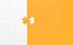 Missing White Jigsaw Puzzle Pieces On Orange Background Copy Space For Your Text. Business Concept. 