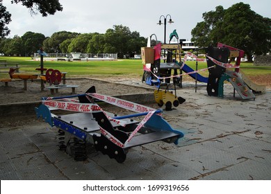 Mission Bay, Auckland / New Zealand - March 27 2020: Police Emergency Red And White Warning Tape On Children's Outdoor Playground Slide, And Equipment To Prevent Use During The Coronavirus Lockdown.