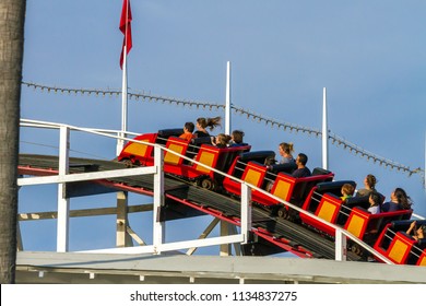 MISSION BAY, CA-USA-11 JULY 2018- People Ride Giant Dipper Roller Coaster At Belmont Park. Going Up, Shows Wheels On Track. The Mission Beach Roller Coaster, Wooden Built In 1925 By Prior And Church.