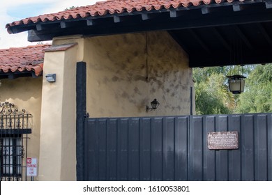 Mission Hills, California / USA -  January 7, 2020: Main Gate And Entry Admissions And Mass Services Hours Sign At The Historical Spanish Mission San Fernando Rey De España.