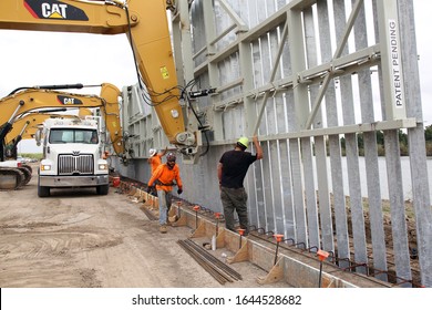 Mission, Tx/USA - Jan. 16, 2020: Construction Workers Check The Placement Of A Panel Of A Non - U.S. Government Border Wall Being Constructed With Private Funds On The Rio Grande River.