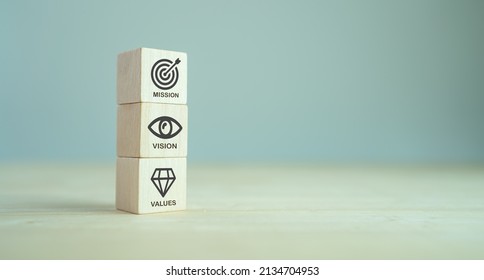 Mission, Vision And Values Of Company. Purpose Business Concept. The Wooden Cube With Mission, Vision And Values Symbols On Grey Background, Copy Space. Modern Stacking Design. Business Presentation. 