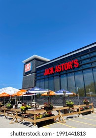 Mississauga, Canada - 15 June 2021: The Exterior And Empty Patio Area Of A Jack Astor’s Bar And Grill Restaurant On A Sunny Day With Blue Sky With No People