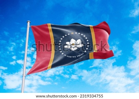 Mississippi flag waving in the wind, blue sky background