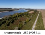 Mississippi River with barges during the fall dry season. Missouri and Illinois riverbanks