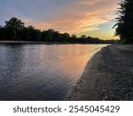 The Mississippi River during sunset. Taken from a beach and looking towards a bend in the river.