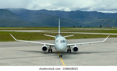 MISSOULA MONTANA AIRPORT, MT, JUN 2022: American Airlines Embraer E175 Passenger Jet Aircraft Seen From Front, On Taxiway, With Mountains In Background