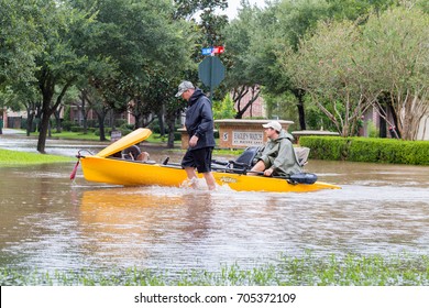 Missouri City, Texas - August 29, 2017: Residents of Sienna Plantation Houston suburb rde a canoe in high waters. Heavy rains from hurricane Harvey caused floods in many areas around Houston.