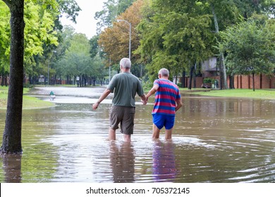 Missouri City, Texas - August 29, 2017: Residents of Sienna Plantation, a Houston suburb walk in high waters. Heavy rains from hurricane Harvey caused floods in many areas around Houston.