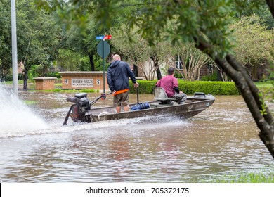 Missouri City, Texas - August 29, 2017: Volunteers from Austin ride a boat in the flooded street, helping local residents to evacuate. Heavy rains from hurricane Harvey caused many floods near Houston