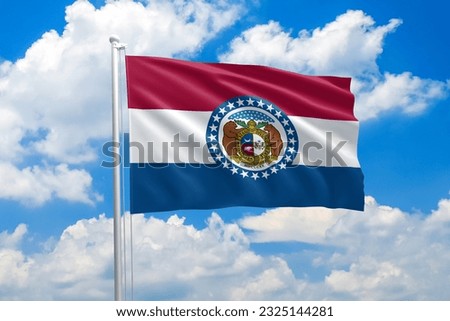 Missouri flag waving in the wind on clouds sky. High quality fabric. International relations concept