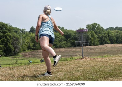 MISSOURI, UNITED STATES - Jul 31, 2020: A Woman Playing Disc Frisbee Golf