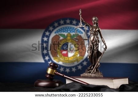 Missouri US state flag with statue of lady justice, constitution and judge hammer on black drapery. Concept of judgement and punishment