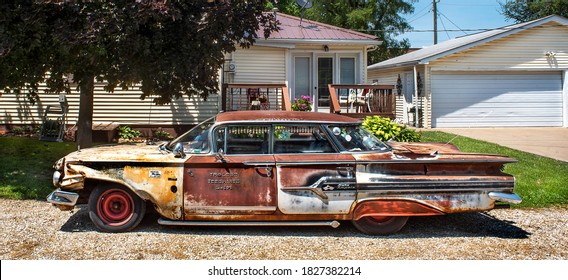 Missouri, USA, June 15, 2020 - Custom 1960s Lowrider SS Chevy Impala Car In Front Of House. Beat Up, Rusty, Paint Peeling, Dents, Weird, Odd, Customer, Junk Car