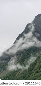 Mist and Clouds Wrapping Around Steep Mountain Slope in Norway, Dramatic Nordic Landscape