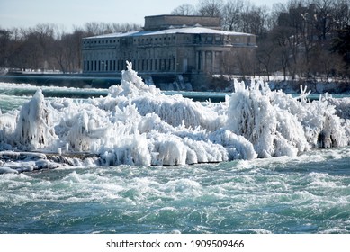 Mist From Niagara Falls Freezes On Tree Branches And Shrubs On An Island In The Niagara River.  An Old Power Plant Building Is In The Background.